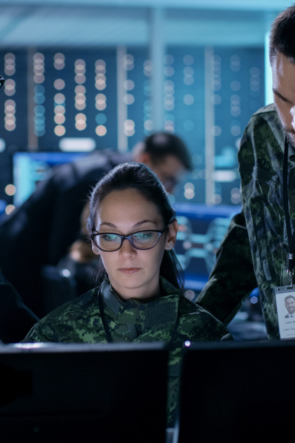 Information Security illusration: government surveillance agency and military joint operation. male agent, female and male military officers working at system control center.